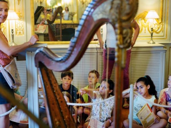 Children listening to a harp concert